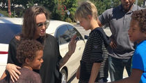Angelina Jolie -- Help$ Kids Unload 8 Foot Tall Teddy Bear! (VIDEO + PHOTOS)